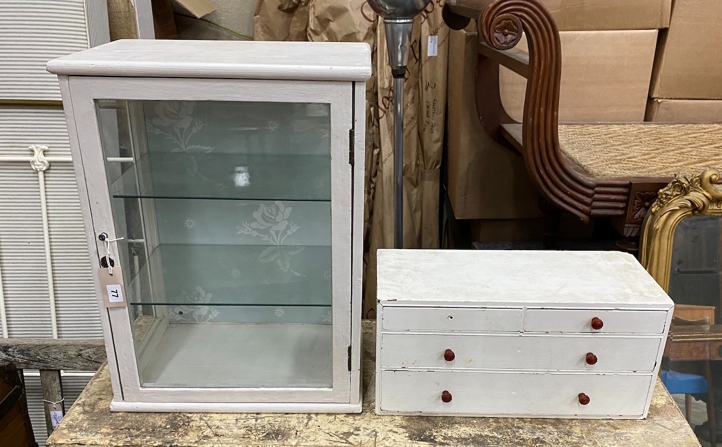 An early 20th century counter top display cabinet, later painted, width 46cm, depth 30cm, height 60cm together with a small pine nest of drawers